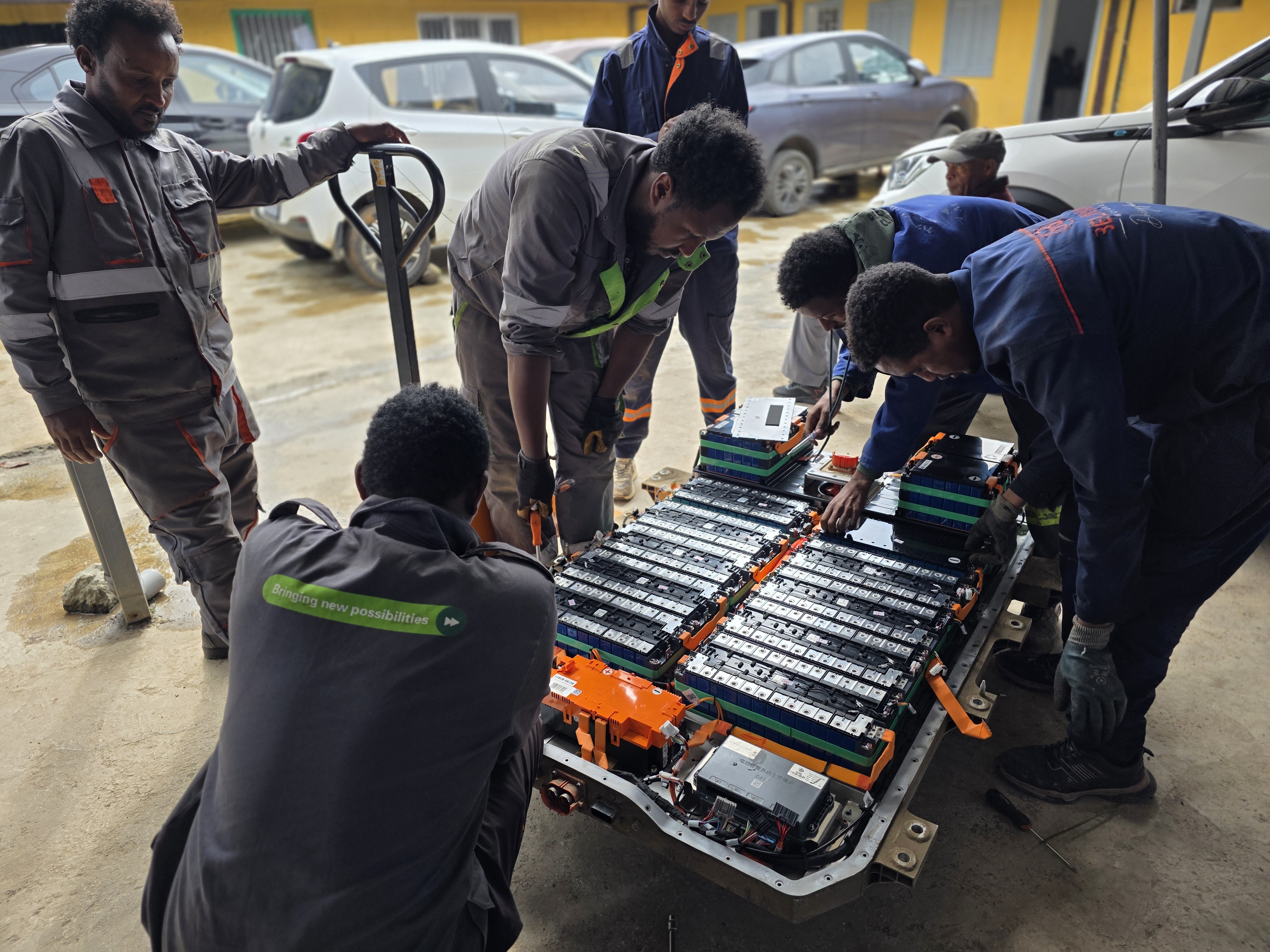 An expert technician servicing an electric vehicle